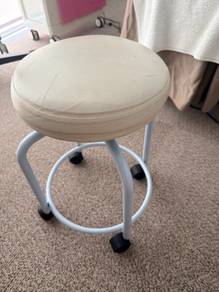 White padded stool with wheels